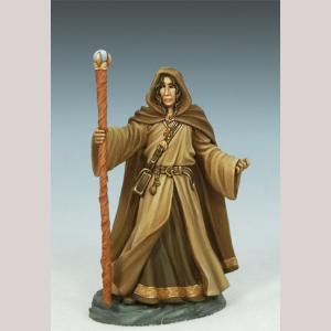 A young male human wizard standing still. He is wearing several thick robes, one on top of the other. A hood covers his head, and a full length cloak covers his back. One hand is empty, but his other holds onto a finely crafted slender staff.