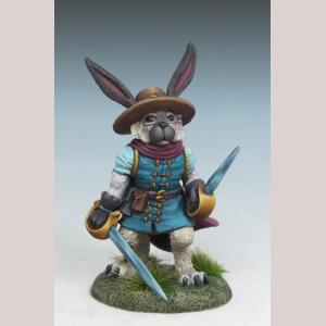 An anthropomorphic rabbit swashbuckler advancing. He wears a simple tunic with a short sleeved shirt beneath. A wide brimmed hat sits on his head, and a narrow cloak hangs over his back. In each hand he holds a sword, one raised, the other lowered.
