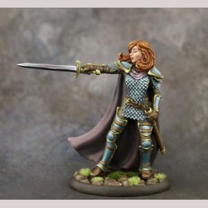 A female human fighter challenging with her outstretched sword. She wears a shirt with a scale mail vest over the top. Her legs are covered with plate armour pieces and greaves. A full length cloak covers her back. One arm rests by her side. The other is extended and holds the pointing sword.