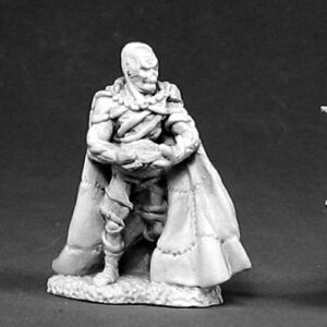 A male humanoid with a skull-like head. He is fully clothed and wears a floor length cloak. In his hands he is holding a small round disc.
