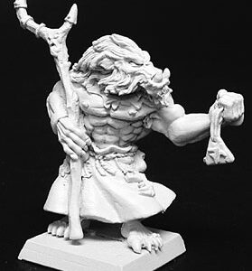 A male beastman standing, while holding a talisman in one hand. He is bare chested but wears a simple skirt around his waist. His other hand holds a rustic wooden staff close to his body.