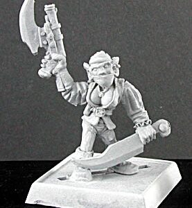 A female goblin pirate holding a pistol above her head. She is dressed in close fitting clothing, boots and a headscarf. Most of her face is covered with a fabric mask. One hand is low by her side and holds the handle of a large knife.