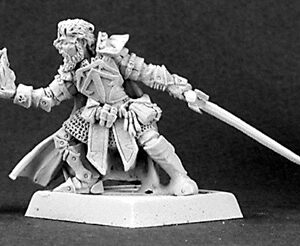 A male human fighter / wizard. He is dressed in a mixture of plate armour, with longer robes covering it. With one hand he is stretching forward, magical spellfire bursting from his palm. His other hand holds a sword, trailing behind him.